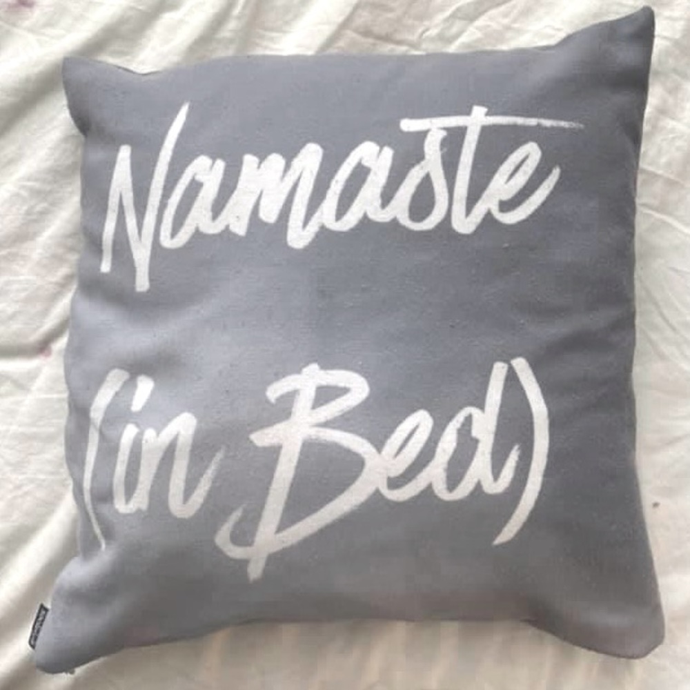 “Namaste in Bed” gray throw pillow